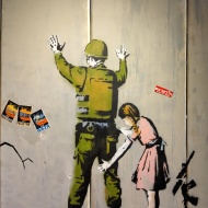 Banksy art - girl checking soldier